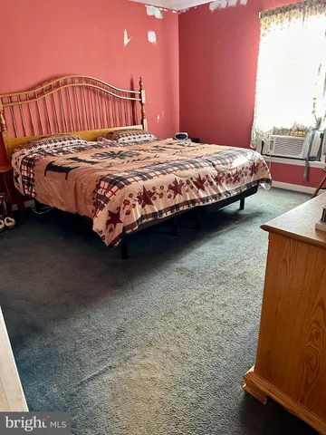 a living room with lots of furniture and a large window