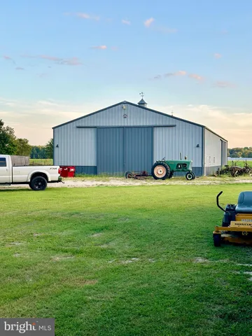 a view of yard with car parked in front of it