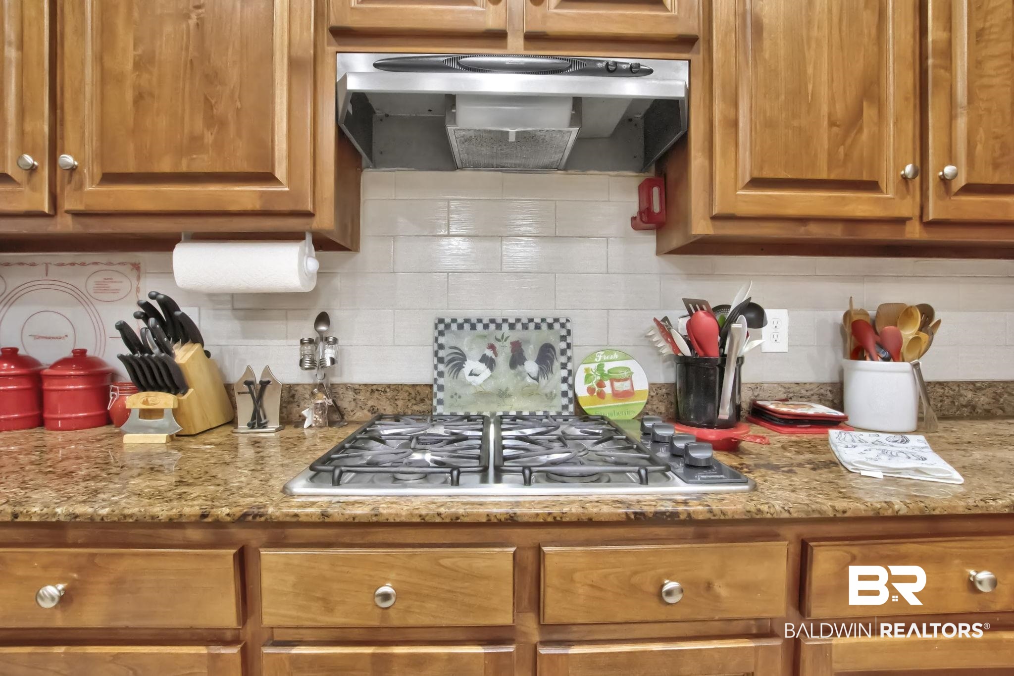 1 Bens Bluff Daphne, AL 36527 - Photo 21 of 56 Kitchen with stainless steel gas stovetop, light stone counters, exhaust hood, and decorative backsplash