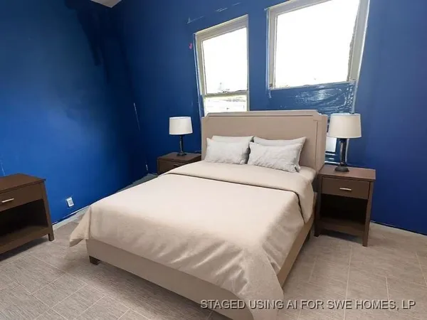 a bedroom with a bed and a night stand