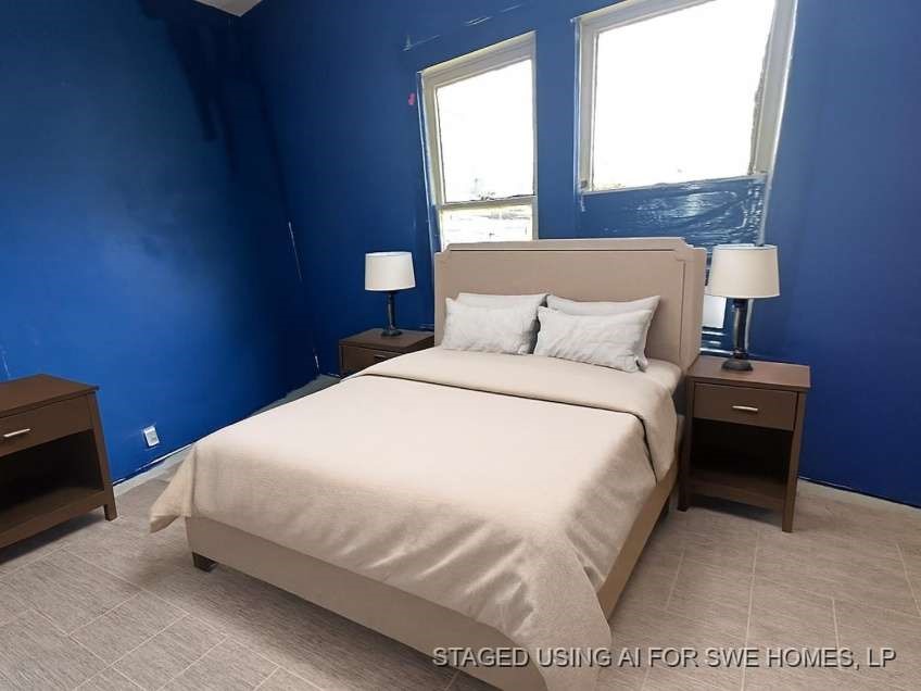 107 Electra Street Longview, TX 75602 - Photo 11 of 12 a bedroom with a bed and a night stand