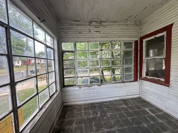 a view of a room with wooden floor and windows