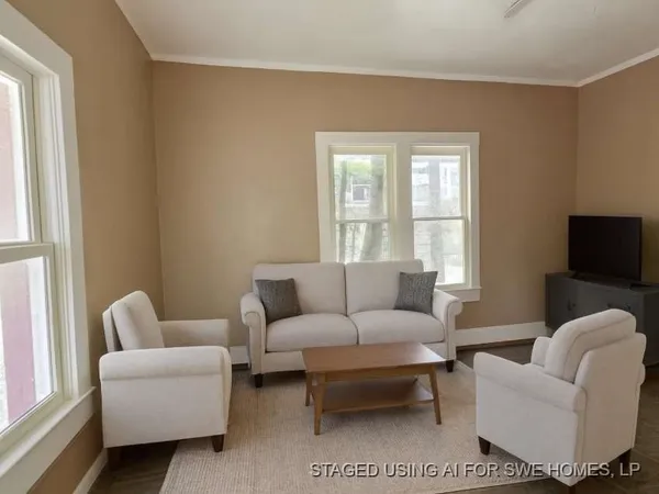 a living room with furniture a couch and a flat screen tv