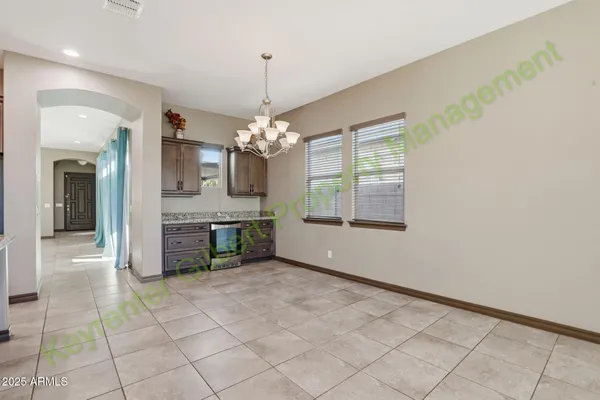 a view of kitchen with refrigerator and microwave