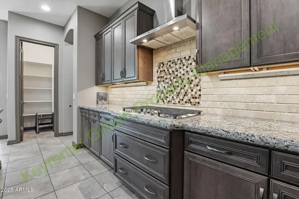 a kitchen with stainless steel appliances granite countertop a sink and a stove