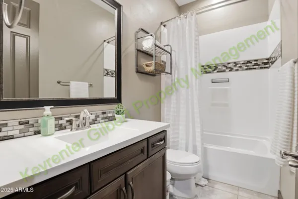 a bathroom with a sink vanity and toilet