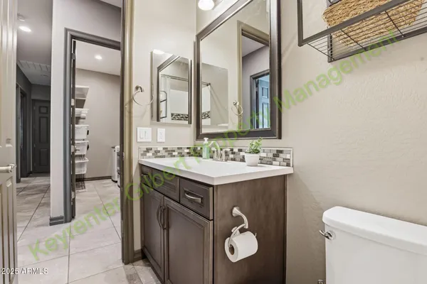 an empty room with windows and ceiling fan