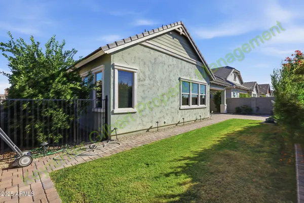 a backyard of a house with potted plants