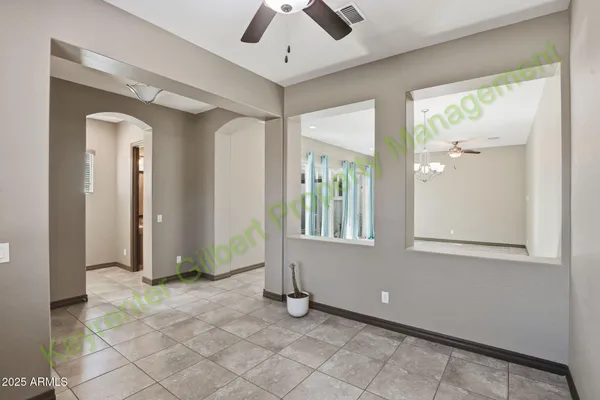 a view of a chandelier fan and entryway