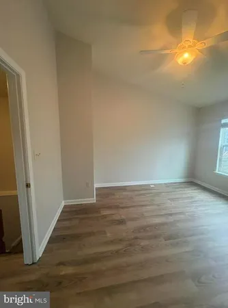 a view of an empty room and wooden floor