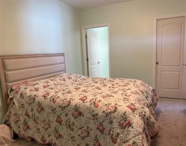 a large bed sitting in a bedroom next to a bathroom