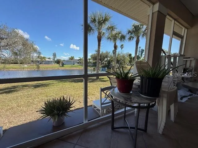 a view of a balcony with chairs and a potted plant