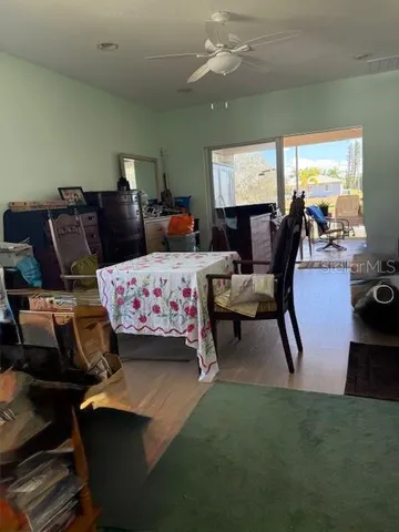 a bedroom with furniture and a large window