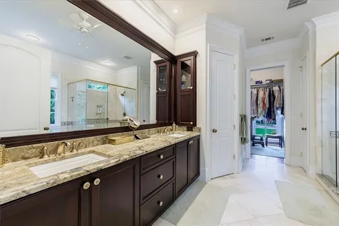 a view of walk in closet with clothes and shoes