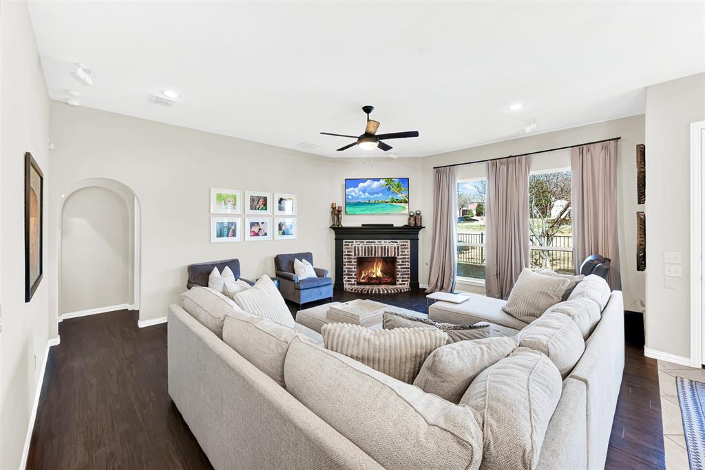 10104 Gentry Drive Frisco, TX 75035 - Photo 14 of 39 a living room with furniture a large window and a fireplace