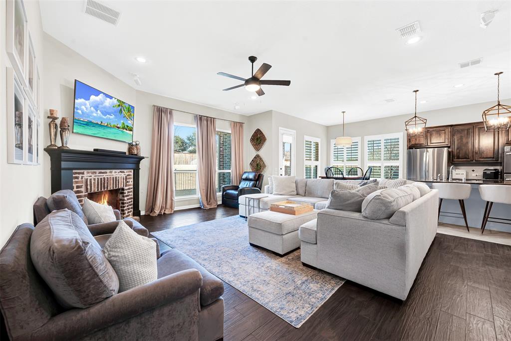 10104 Gentry Drive Frisco, TX 75035 - Photo 15 of 39 a living room with fireplace furniture and a flat screen tv