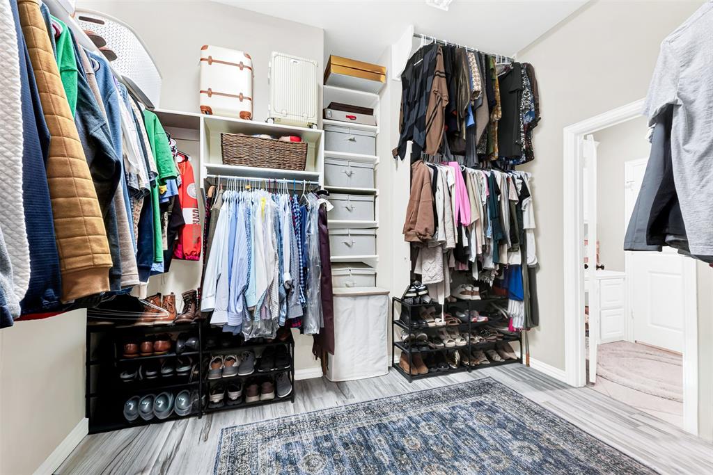10104 Gentry Drive Frisco, TX 75035 - Photo 18 of 39 a view of walk in closet with clothes and shoes