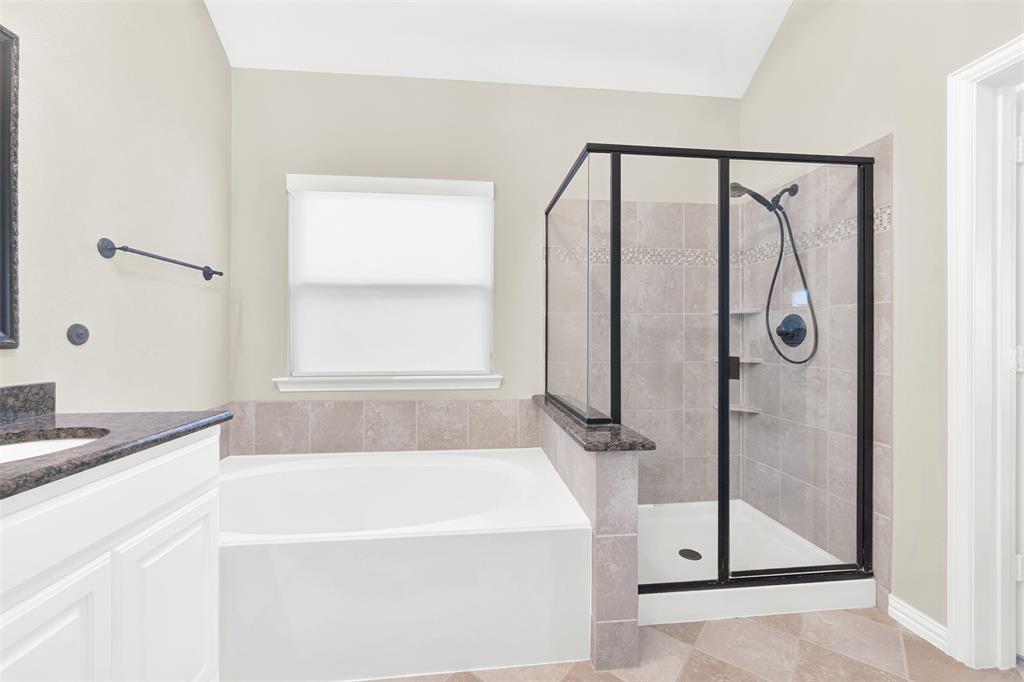 10104 Gentry Drive Frisco, TX 75035 - Photo 20 of 39 a bathroom with a bathtub and a shower