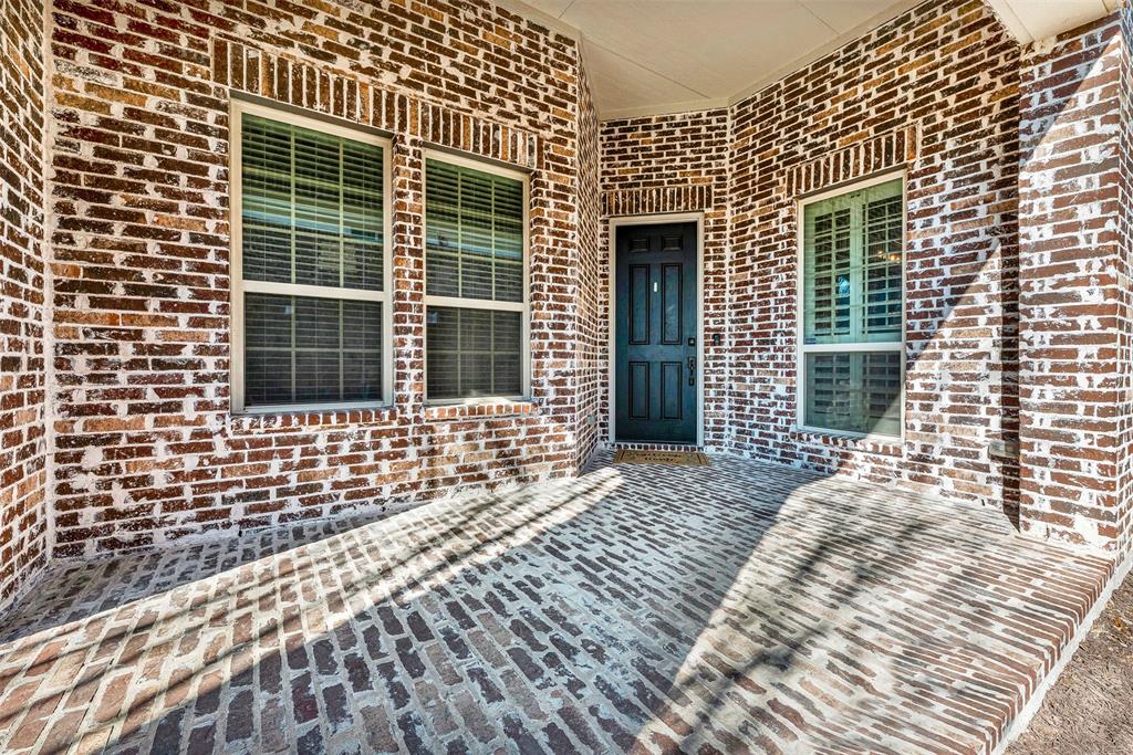 10104 Gentry Drive Frisco, TX 75035 - Photo 4 of 39 a view of a brick house with many windows