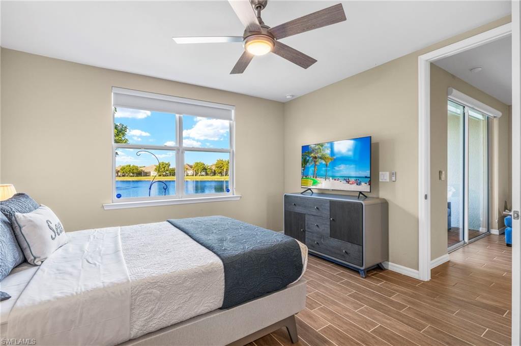 14644 Edgewater Circle Naples, FL 34114 - Photo 14 of 39 a bedroom with a bed and a chandelier