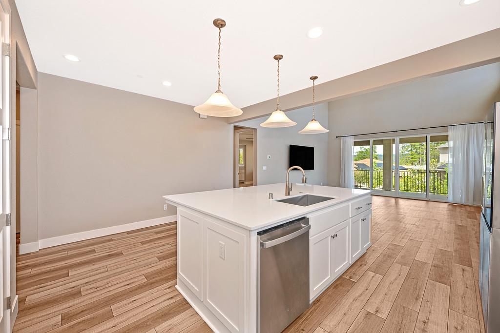 504 Chase Court Colfax, CA 95713 - Photo 38 of 94 a large kitchen with a stove and a wooden floor