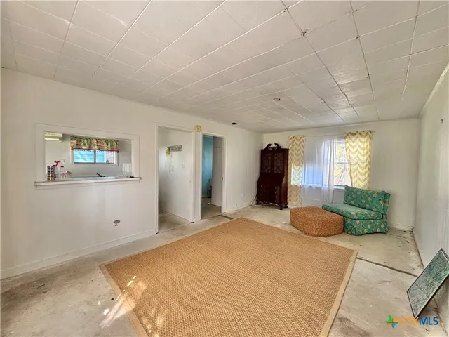 a bedroom with a large bed and ceiling fan