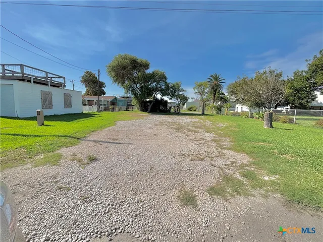 a big yard with large trees
