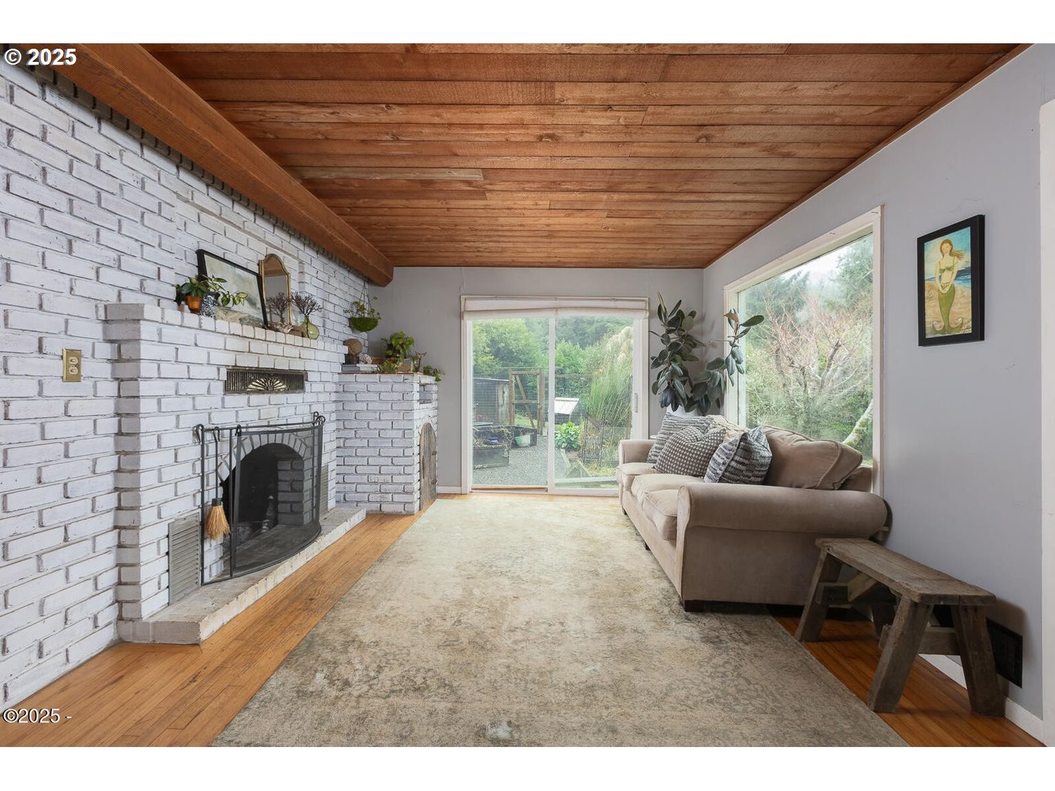 381 South Anderson Creek Road Lincoln City, OR 97367 - Photo 11 of 48 a living room with furniture a fireplace and a table
