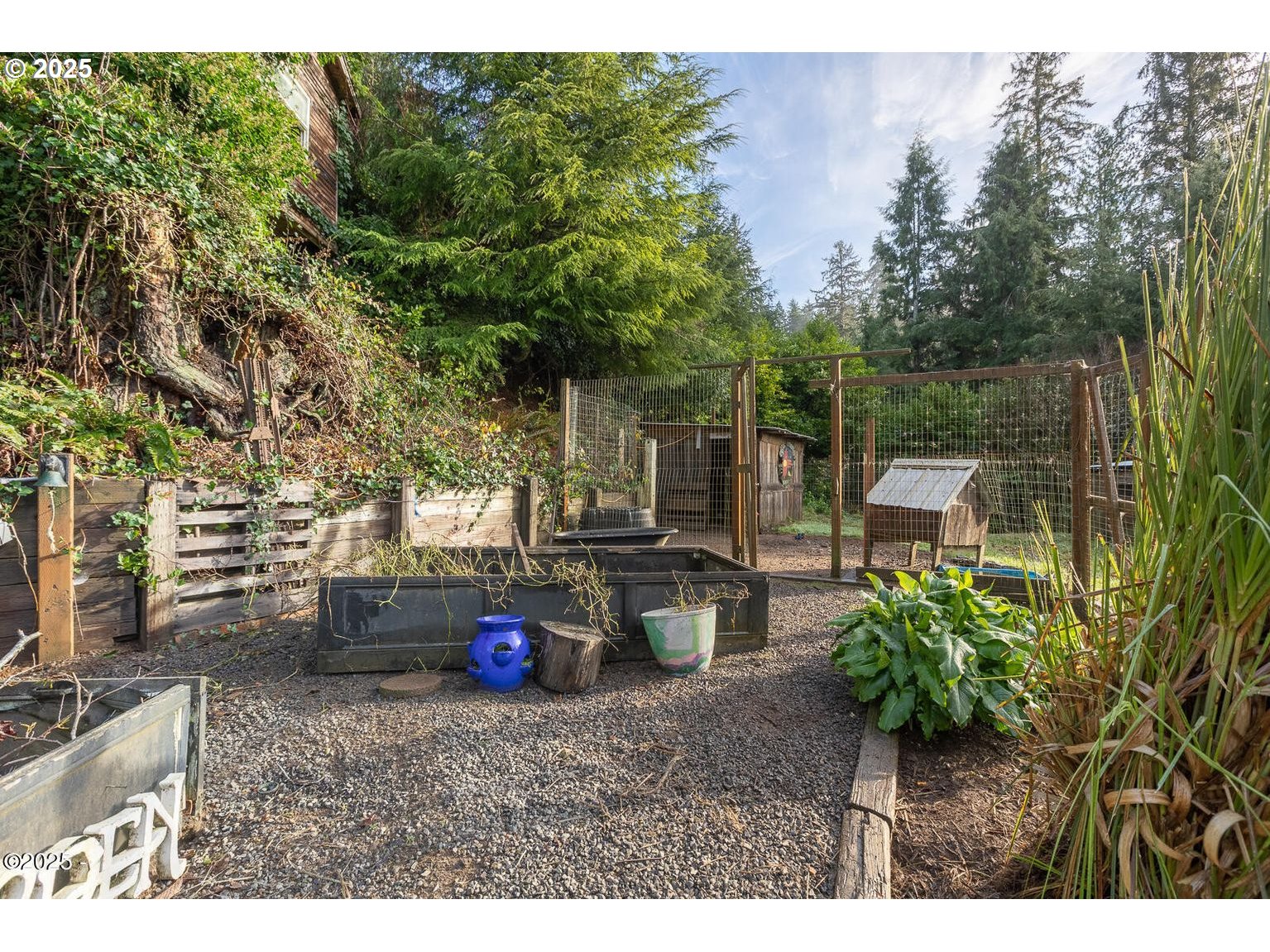 381 South Anderson Creek Road Lincoln City, OR 97367 - Photo 33 of 48 a backyard of a house with barbeque oven table and chairs