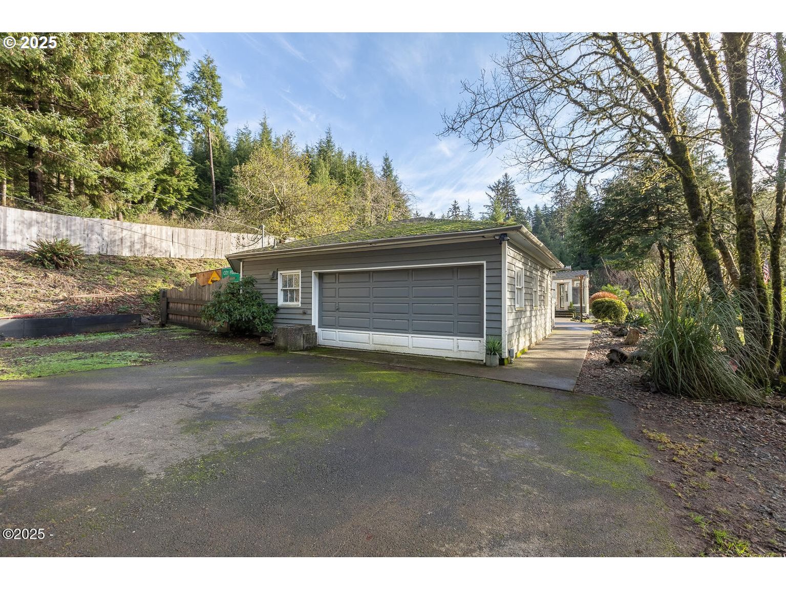381 South Anderson Creek Road Lincoln City, OR 97367 - Photo 5 of 48 a view of a house with a yard and garage