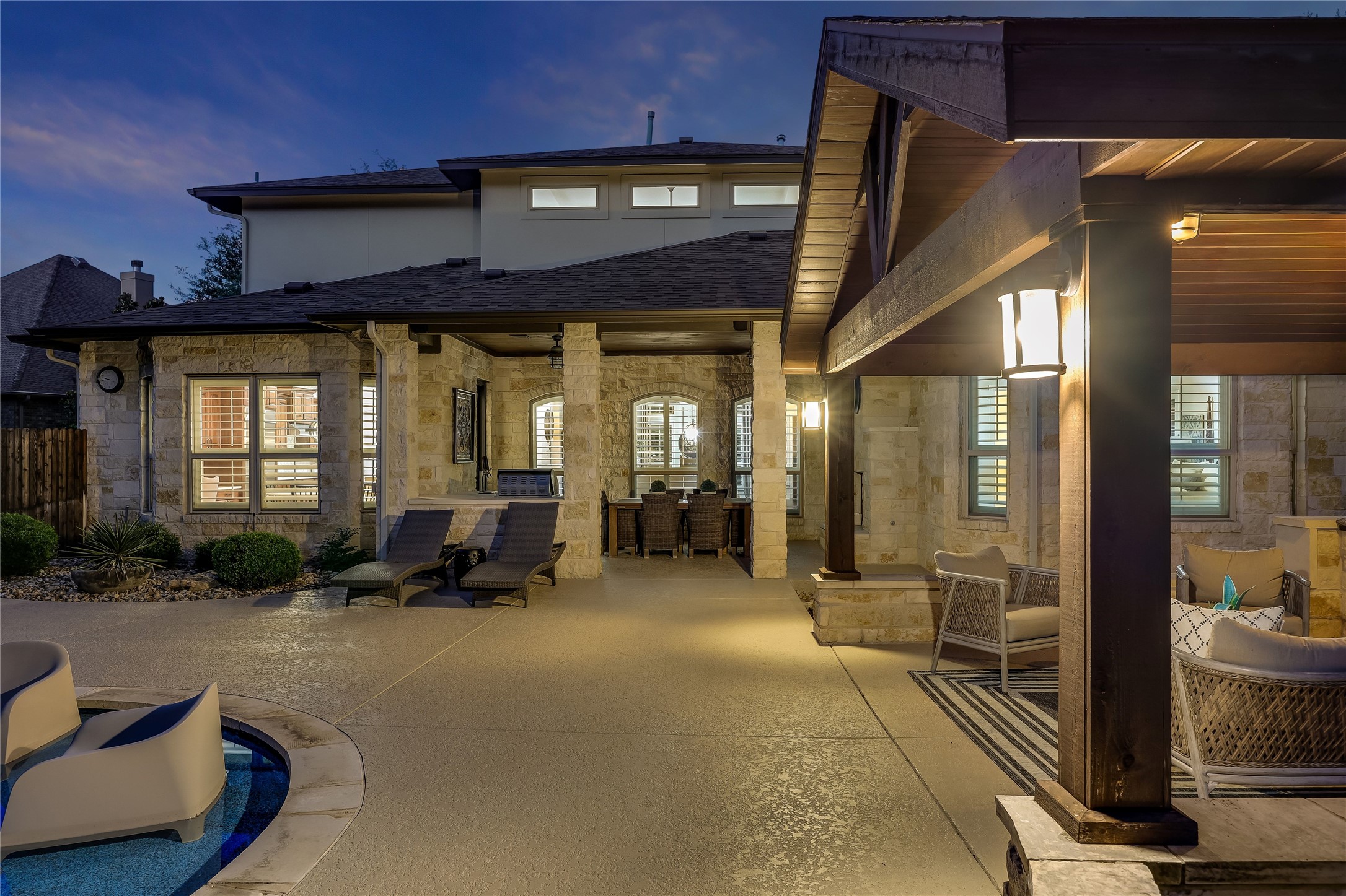401 Bluff View Road Cedar Park, TX 78613 - Photo 18 of 40 An inviting outdoor living space with stone accents and abundant lighting for evening gatherings.