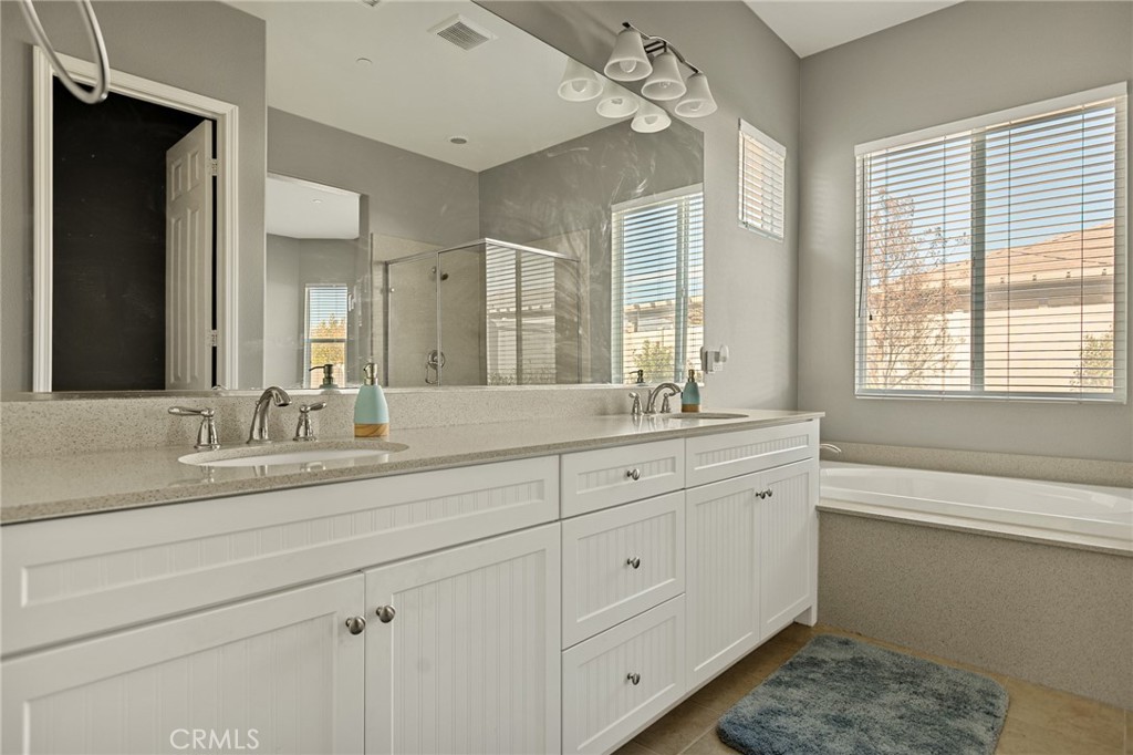1576 Timberline Beaumont, CA 92223 - Photo 12 of 26 a bathroom with double vanity sink a mirror and a shower