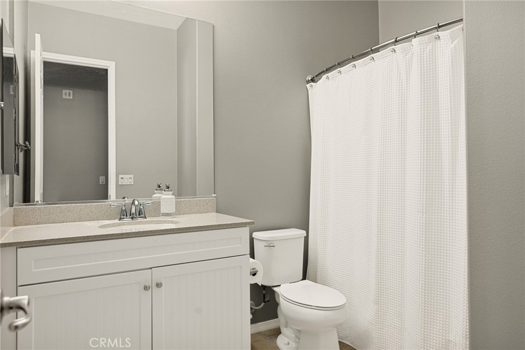 1576 Timberline Beaumont, CA 92223 - Photo 17 of 26 a bathroom with a sink a toilet and a mirror