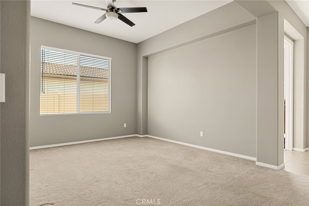 1576 Timberline Beaumont, CA 92223 - Photo 18 of 26 an empty room with a window and a ceiling fan