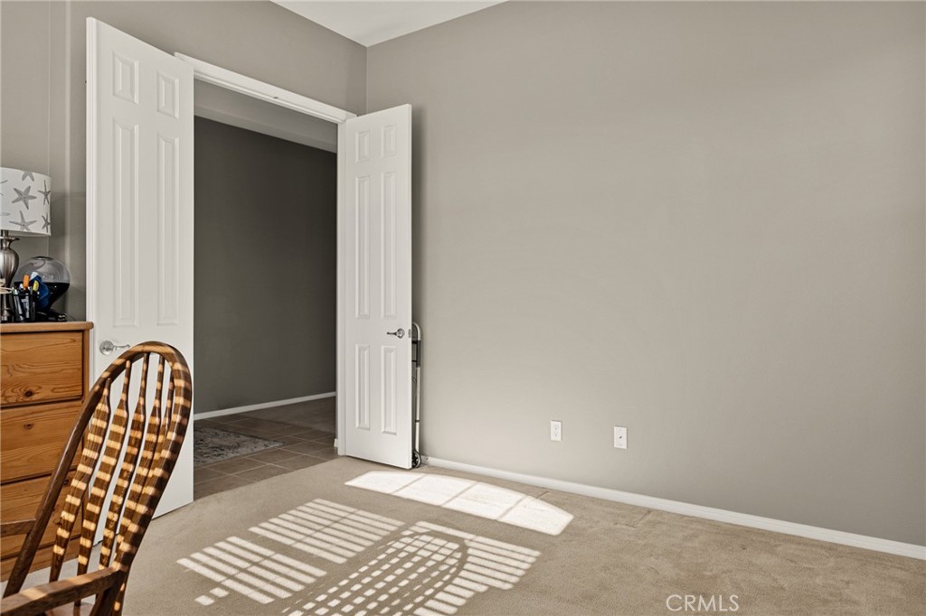 1576 Timberline Beaumont, CA 92223 - Photo 21 of 26 an empty room with wooden floor and windows