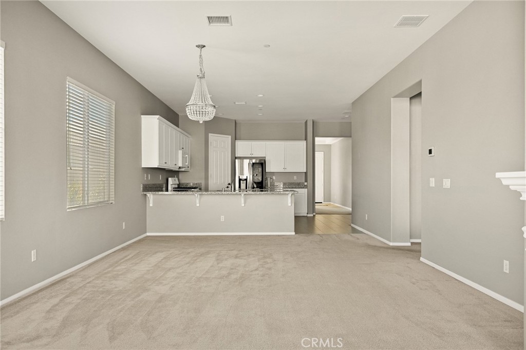 1576 Timberline Beaumont, CA 92223 - Photo 5 of 26 a view of kitchen with granite countertop cabinets and refrigerator
