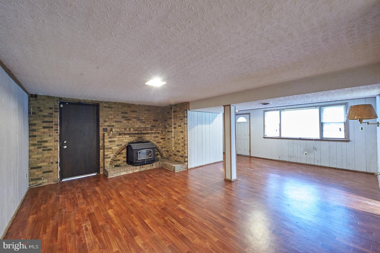4914 Sharon Road Temple Hills, MD 20748 - Photo 16 of 25 family room, firestove, garage and patio entrance