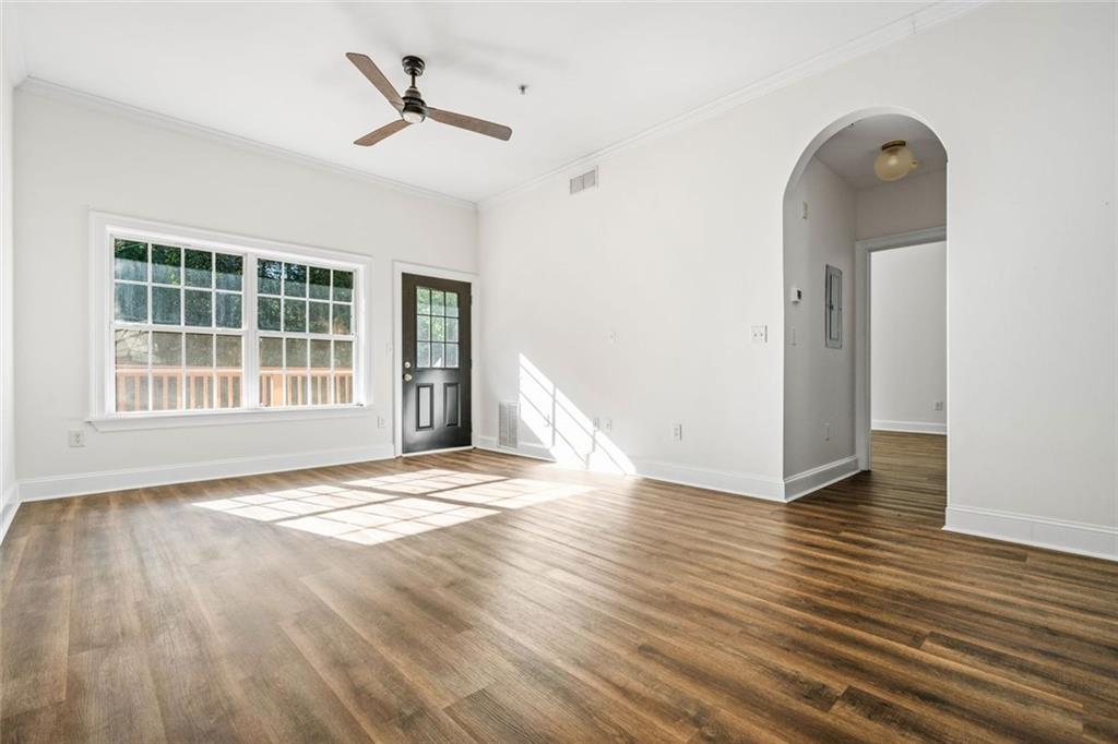 1635 Briarcliff Rd Road, Unit 8 Atlanta, GA 30306 - Photo 11 of 29 a view of an empty room with wooden floor and a window