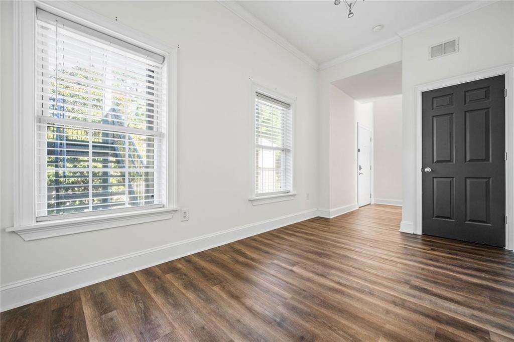 1635 Briarcliff Rd Road, Unit 8 Atlanta, GA 30306 - Photo 14 of 29 a view of an empty room with wooden floor and a window