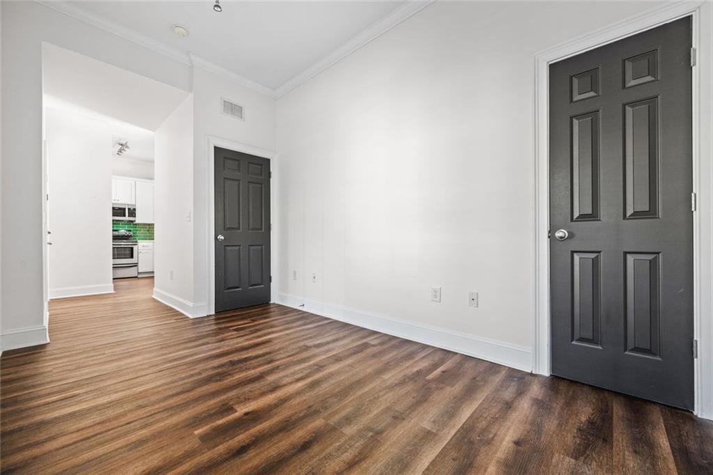 1635 Briarcliff Rd Road, Unit 8 Atlanta, GA 30306 - Photo 17 of 29 an empty room with wooden floor and closet