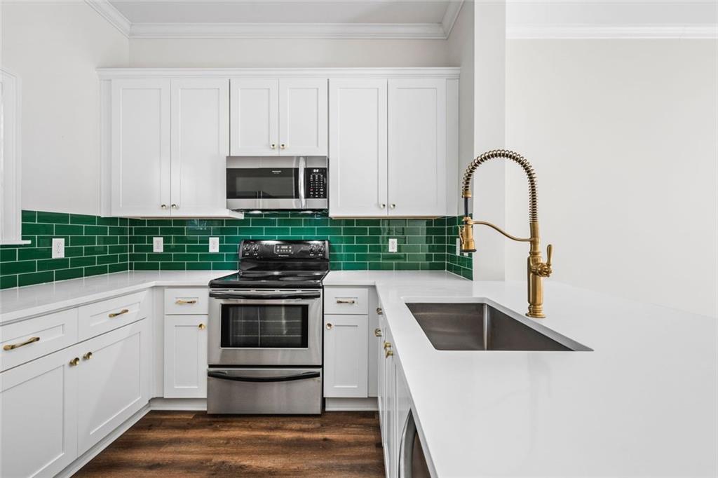 1635 Briarcliff Rd Road, Unit 8 Atlanta, GA 30306 - Photo 2 of 29 a kitchen with granite countertop white cabinets and stainless steel appliances
