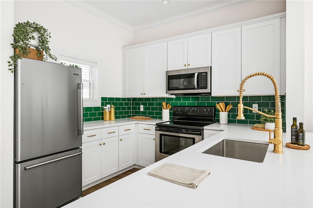 1635 Briarcliff Rd Road, Unit 8 Atlanta, GA 30306 - Photo 4 of 29 a kitchen with granite countertop a refrigerator stove and microwave