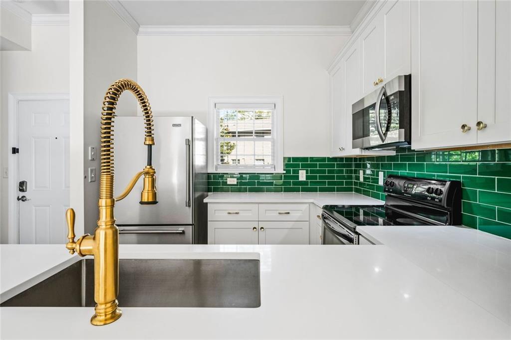 1635 Briarcliff Rd Road, Unit 8 Atlanta, GA 30306 - Photo 6 of 29 a kitchen with a sink a counter and a cabinets