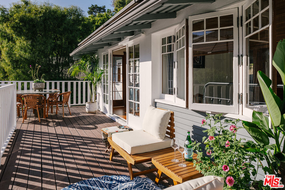 1954 Pinehurst Road Los Angeles, CA 90068 - Photo 13 of 42 a view of a patio with a table and chairs and potted plants