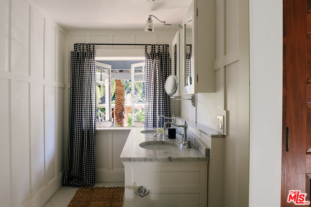 1954 Pinehurst Road Los Angeles, CA 90068 - Photo 28 of 42 a bathroom with a granite countertop sink and a mirror