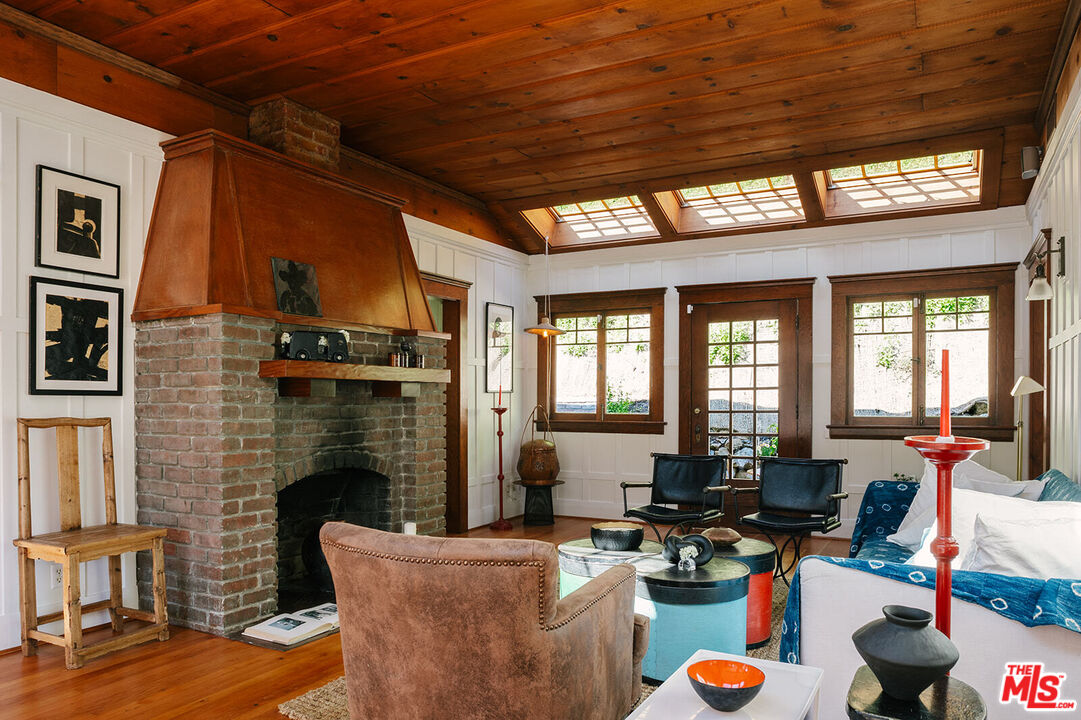1954 Pinehurst Road Los Angeles, CA 90068 - Photo 6 of 42 a living room with patio furniture and a fireplace