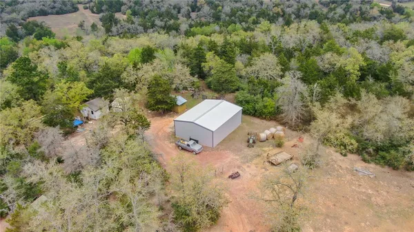 an aerial view of a house with a yard