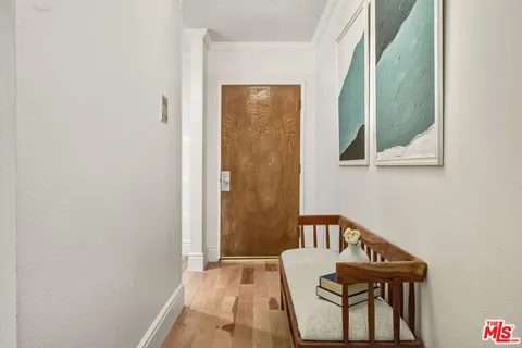 a dining room with furniture and a potted plant