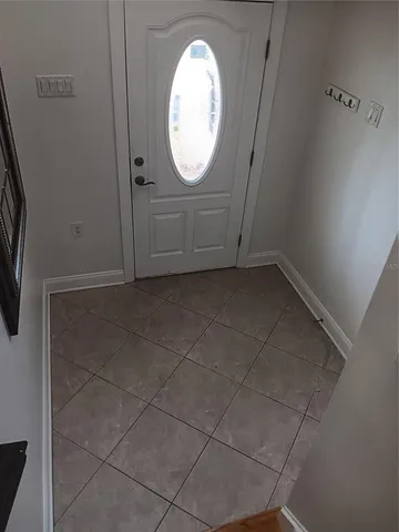 a view of a livingroom with wooden floor and white walls