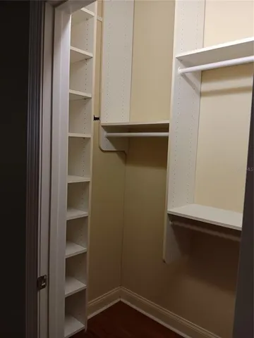 a bathroom with a granite countertop sink a mirror and a shower
